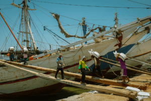 shipping workers loading cargo onto a ship